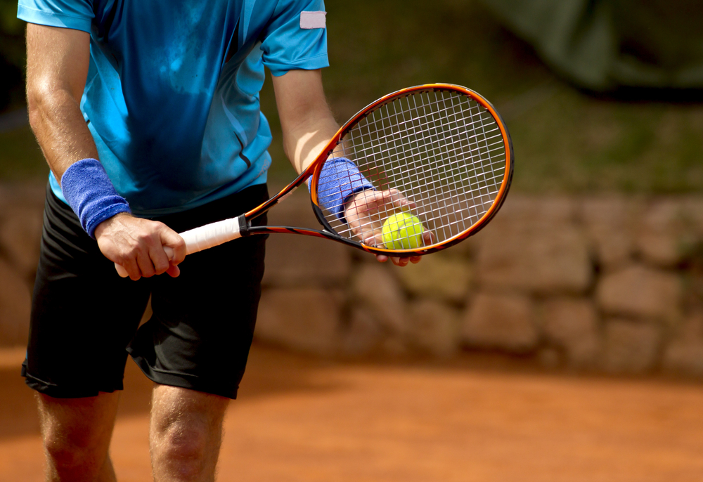 male tennis player ready to serve the ball